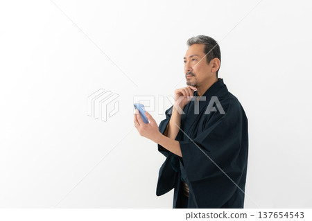 A man wearing a kimono 137654543
