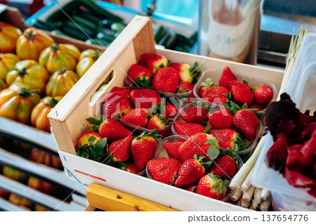 Fresh strawberries in boxes at a local market stand under bright sunlight on a sunny day Fresh strawberries in boxes at a local market stand under bright sunlight on a sunny day 137654776