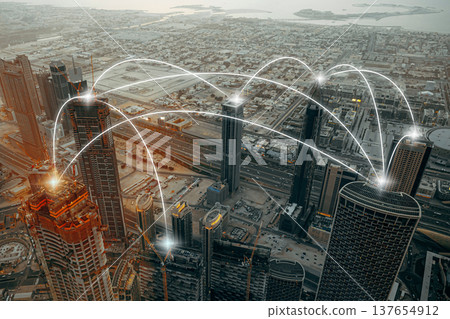 Network connections above the skyline of a bustling city during sunset hours Network connections above the skyline of a bustling city during sunset hours 137654912