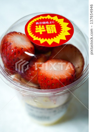 Strawberries in a cup with a half-price sticker (discounted item at a supermarket, image of food waste) Strawberries in a cup with a half-price sticker (discounted item at a supermarket, image of food waste) 137654946