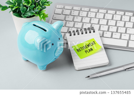Retirement savings and investment plan concept with blue piggy bank, computer keyboard and small plant on work desk Retirement savings and investment plan concept with blue piggy bank, computer keyboard and small plant on work desk 137655485