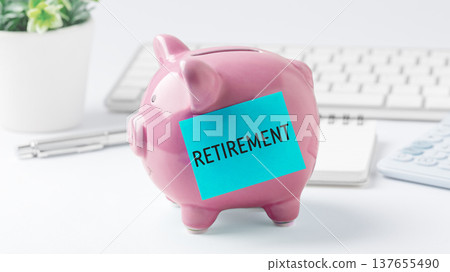 Pink piggy bank with Retirement message on blue sticky note with office supplies on desk for retirement financial planning conceptial planning concept, on white background Pink piggy bank with Retirement message on blue sticky note with office supplies on desk for retirement financial planning conceptial planning concept, on white background 137655490