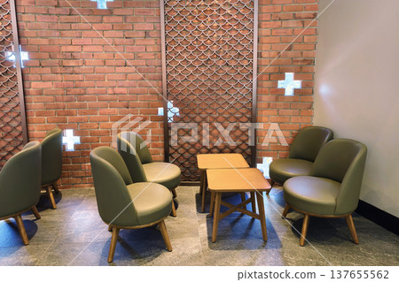Cafe chairs and table by brick wall with plus holes Cafe chairs and table by brick wall with plus holes 137655562