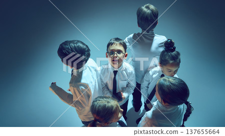 Kids standing together in neon studio representing online communication generation concept Kids standing together in neon studio representing online communication generation concept 137655664