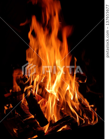 It is a flame rising from a bonfire. It is a flame rising from a bonfire. 137655677