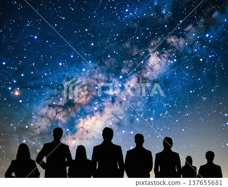 People stand together under a night sky full of stars and a bright galaxy in a cinematic double exposure scene 137655681