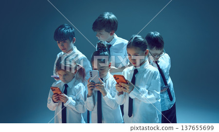 Kids using smartphones in neon studio 137655699