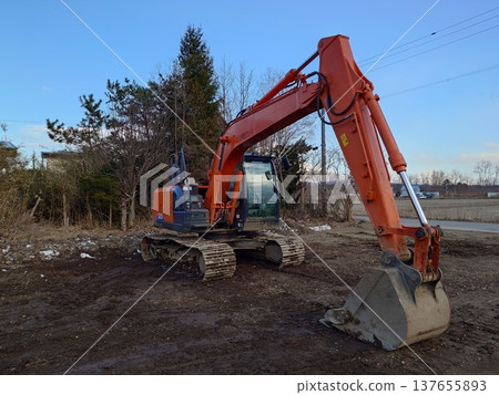 Hydraulic excavators in use at civil engineering sites 137655893