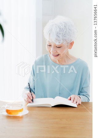 Senior women writing end-of-life notebooks Senior women writing end-of-life notebooks 137656641