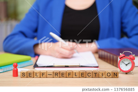 Self-reflection through writing and planning in a cozy workspace with a vintage clock and personal touches Self-reflection through writing and planning in a cozy workspace with a vintage clock and personal touches 137656885