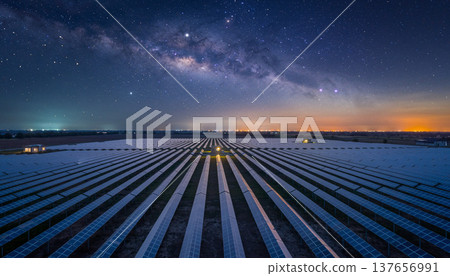 Long exposure captures solar panels under night sky near city with stars and Milky Way visible in the background 137656991