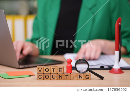 Vote counting in a modern office with tools and focus on accuracy during an important democratic process Vote counting in a modern office with tools and focus on accuracy during an important democratic process 137656992