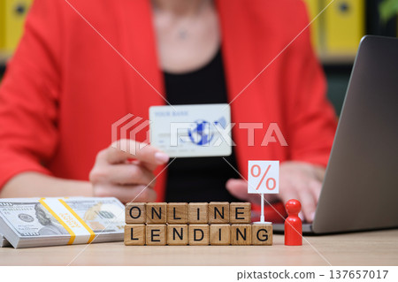 Exploring online lending with credit card and cash transactions during a business meeting at a modern workspace 137657017