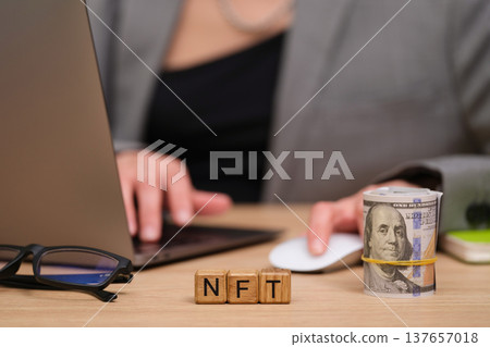 Engaging in digital finance with NFTs and cash on a modern workspace desk Engaging in digital finance with NFTs and cash on a modern workspace desk 137657018