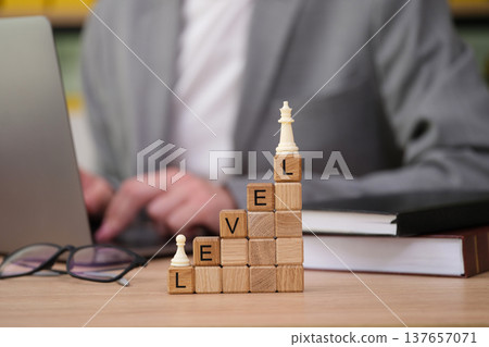 Building success with strategic thinking on a wooden chessboard in a modern workspace Building success with strategic thinking on a wooden chessboard in a modern workspace 137657071