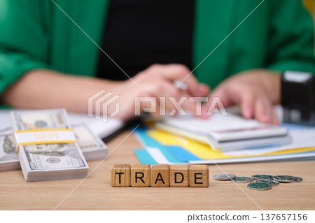 Exploring the world of finance through trade and investment strategies with money and planning documents in a cozy office setting Exploring the world of finance through trade and investment strategies with money and planning documents in a cozy office setting 137657156