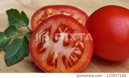 Fresh red tomatoes in a wooden plate. Fresh red tomatoes in a wooden plate. 137657180