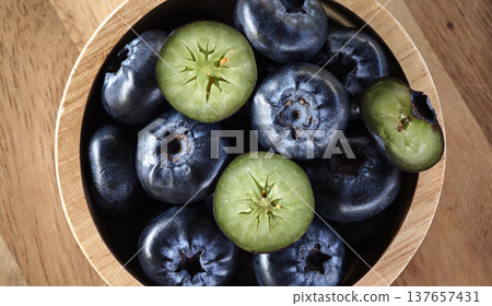 Close up Fresh blueberries healthy food in wooden bowl 137657431