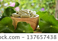 Herbal capsules containing Centella asiatica powder in a wooden bowl. A natural dietary supplement. 137657438