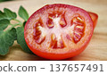 Fresh red tomatoes in a wooden plate. 137657491