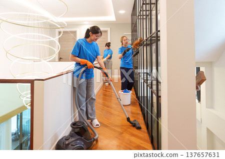 Cleaning Team. Women working together to clean a modern home interior. 137657631