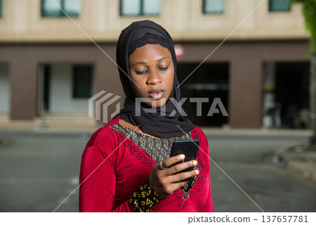 young muslim woman with mobile phone. 137657781