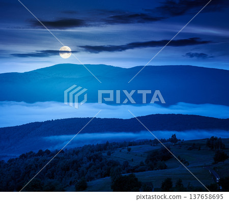 mountainous rural area during springtime at night. full moon over remote mountain landscape with forested rolling hills. mysterious foggy place of alpine countryside wallpaper 137658695