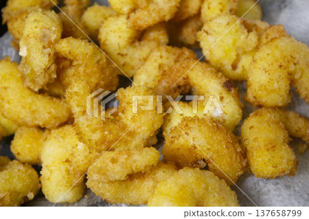 it is  cooking shrimp tempura. 137658799