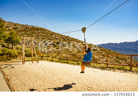 Adult woman having fun on zipline Adult woman having fun on zipline 137658813