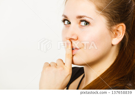 Woman showing silence gesture with finger 137658839