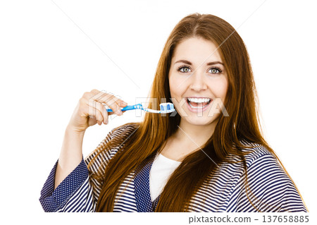 Woman holds toothbrush with paste. Woman holds toothbrush with paste. 137658885