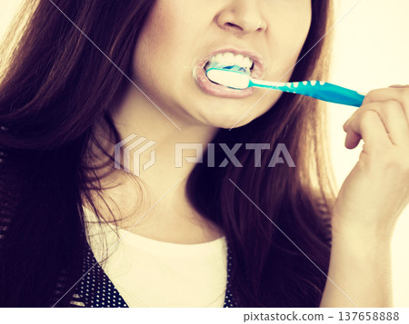 Woman brushing cleaning teeth. 137658888