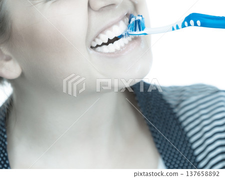Woman brushing cleaning teeth. Woman brushing cleaning teeth. 137658892
