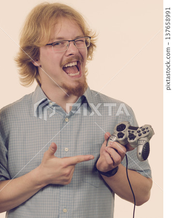 Gamer man holding gaming pad Gamer man holding gaming pad 137658991