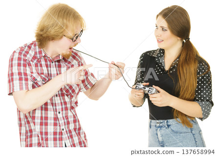 Woman controling man using gaming pad Woman controling man using gaming pad 137658994