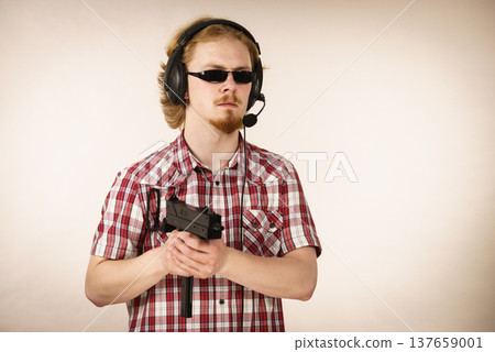 Gamer man shooting from gun Gamer man shooting from gun 137659001