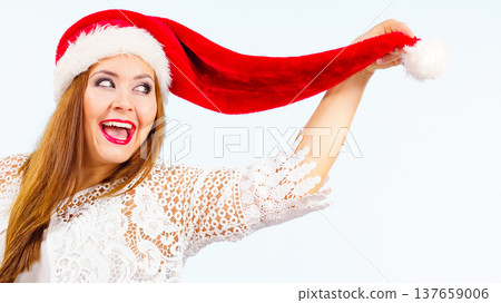 Excited woman in christmas santa hat Excited woman in christmas santa hat 137659006