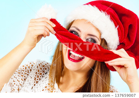 Happy woman in christmas santa hat Happy woman in christmas santa hat 137659007