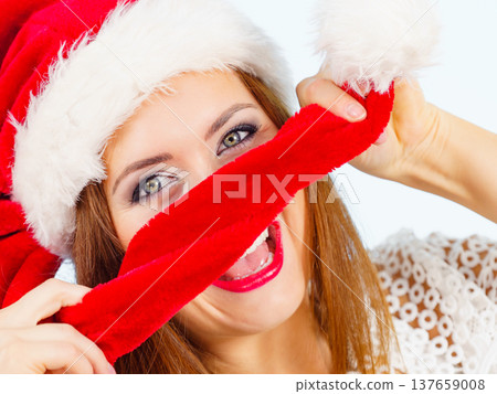 Happy woman in christmas santa hat 137659008