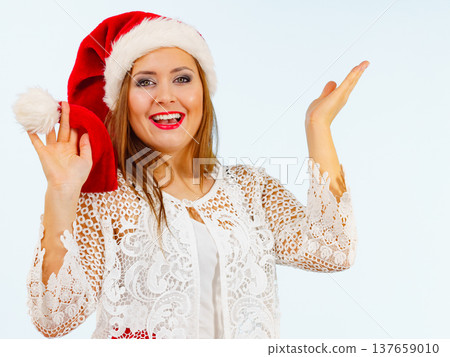 Excited woman in christmas santa hat Excited woman in christmas santa hat 137659010