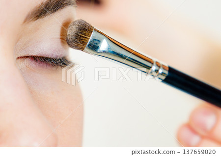Makeup artist applying eye make up Makeup artist applying eye make up 137659020