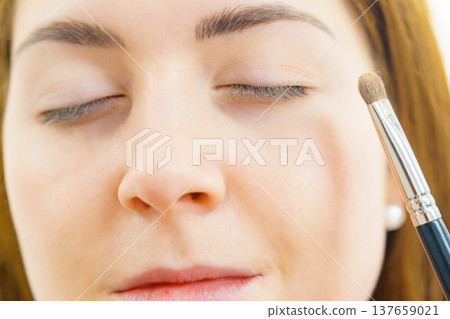 Makeup artist applying eye make up Makeup artist applying eye make up 137659021