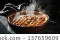 Freshly baked pie emits steam while resting on a dark surface in a cozy kitchen setting during the afternoon 137659609