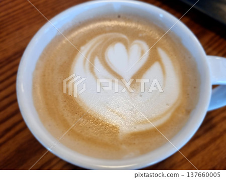 This is latte art in a coffee cup.	 137660005