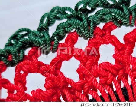 Handmade knitting: Hand-knitted lace scrunchie stitches in red and green. Handmade knitting: Hand-knitted lace scrunchie stitches in red and green. 137660312