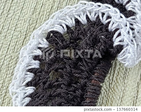 Handmade knitting: Hand-knitted lace scrunchie stitches in white and black. Handmade knitting: Hand-knitted lace scrunchie stitches in white and black. 137660314