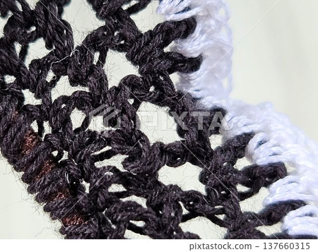 Handmade knitting: Hand-knitted lace scrunchie stitches in white and black. Handmade knitting: Hand-knitted lace scrunchie stitches in white and black. 137660315