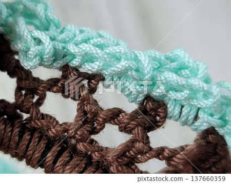 Handmade knitting: Hand-knitted lace scrunchie stitches in brown and mint green. 137660359