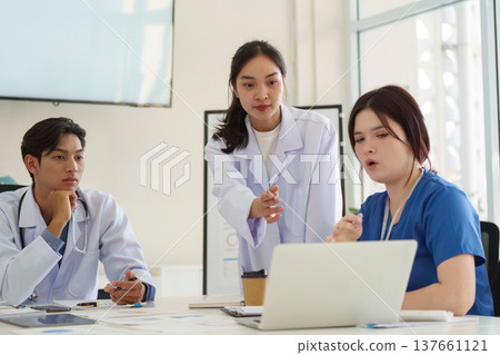 Healthcare team discussing patient care solutions using technology in a meeting Healthcare team discussing patient care solutions using technology in a meeting 137661121