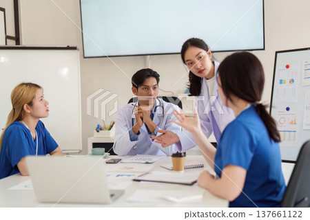 Healthcare Team Collaboration. Medical professionals discussing patient care strategies in a modern office. 137661122